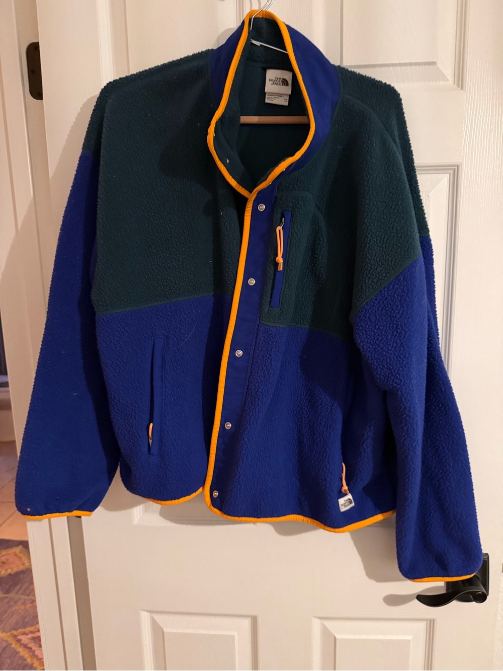 The North Face women’s Two-Tone Fleece Jacket in Blue & Green with orange trim